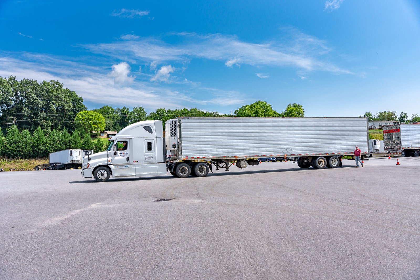 Carolina CDL graduate beside a tractor-trailer